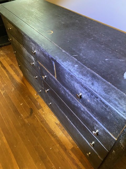 Powdery surface mold bloom on a wood dresser
